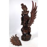 A CARVED ASIAN POLYCHROME FIGURE ON A WINGED BEAST