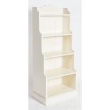 A MODERN WHITE PAINTED FOUR TIER WATERFALL BOOKCASE
