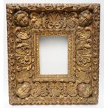 A 19TH CENTURY CARVED AND GOLD PAINTED MIRROR/PICTURE FRAME