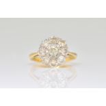 A GOLD AND DIAMOND NINE STONE CLUSTER RING