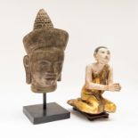 A KHMER STYLE BRONZE HEAD OF BUDDHA, CAMBODIA, AND A PAINTED WOODEN BUDDHIST MONK (2)