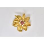 A GOLD, RUBY AND DIAMOND FLOWERHEAD BROOCH, DETAILED 750