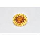 A GOLD AND CITRINE OVAL BROOCH