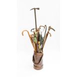 A LEATHER CORDITE/AMMUNITION BUCKET AND COLLECTION OF WALKING STICKS AND UMBRELLAS (17)