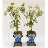 A PAIR OF GILT-METAL MOUNTED BLUE AND WHITE CHINOISERIE DECORATED CERAMIC JARDINIERES (2)