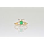 A GOLD, EMERALD AND DIAMOND RECTANGULAR CLUSTER RING