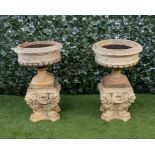DOULTON AND CO; A PAIR OF TERRACOTTA JARDINIERES ON OPPOSING LION STAND (2)
