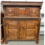 A 17TH CENTURY CARVED OAK COURT CUPBOARD