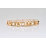 A GOLD, CULTURED PEARL AND DIAMOND OVAL HINGED BANGLE