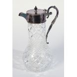 A SILVER MOUNTED MOULDED FACETED GLASS CLARET JUG