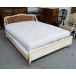 AN EARLY 20TH CENTURY FRENCH PARCEL GILT POLYCHROME PAINTED FLORAL CARVED DOUBLE BED