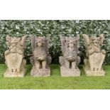 A PAIR OF RECONSTITUTED STONE FIGURES OF SEJANT GRIFFINS (4)