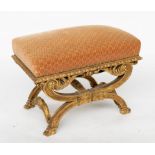 A 19TH CENTURY GILT FRAMED RECTANGULAR STOOL ON CARVED X-FRAME BASE