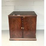 A MAHOGANY TWO DOOR COIN CABINET