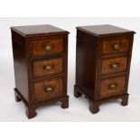 A PAIR OF WALNUT THREE DRAWER BEDSIDE TABLES (2)