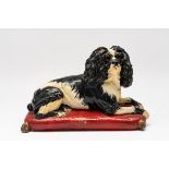A PAINTED TERRACOTTA MODEL OF KING CHARLES SPANIEL