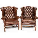 A PAIR OF 18TH CENTURY STYLE BROWN LEATHER UPHOLSTERED WING BACK ARMCHAIRS (2)