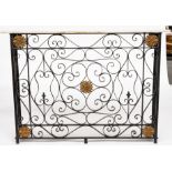 A PARCEL-GILT WROUGHT IRON RADIATOR COVER