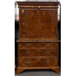 A WILLIAM & MARY FEATHER-BANDED WALNUT SECRETAIRE ON CHEST