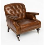 A STUDDED TAN LEATHER UPHOLSTERED EASY ARMCHAIR ON TURNED SUPPORTS