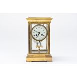 A FRENCH BRASS FOUR GLASS MANTLE CLOCK