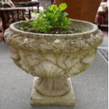 A RECONSTITUTED STONE JARDINIERE WITH FLORAL MOULDED BODY
