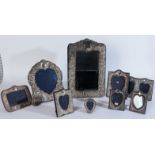 A SILVER MOUNTED MIRROR AND EIGHT PHOTOGRAPH FRAMES (9)