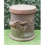 AN EASTERN TERRACOTTA CIRCULAR GARDEN TABLE, THE COLUMN RELIEF MOULDED WITH A DRAGON
