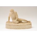 AN ITALIAN CARVED ALABASTER SCULPTURE OF THE DYING GAUL, AFTER THE ANTIQUE