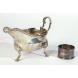A SILVER SAUCEBOAT AND A SILVER NAPKIN RING (2)