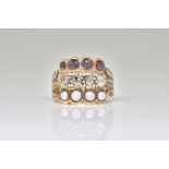 A GOLD, DIAMOND, GARNET AND HALF PEARL SET RING