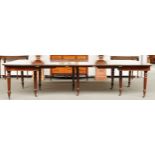 A REGENCY MAHOGANY EXTENDING DINING TABLE ON REEDED SUPPORTS TO INCLUDE FOUR EXTRA LEAVES