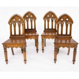A SET OF FOUR GOTHIC DESIGN ARCH BACK OAK HALL CHAIRS (4)