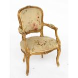 A 19TH CENTURY FRENCH GILT FRAMED CHILD’S OPEN ARMCHAIR OF 18TH CENTURY DESIGN