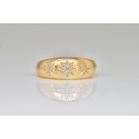 AN 18CT GOLD AND DIAMOND THREE STONE RING