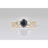 A GOLD AND PLATINUM, SAPPHIRE AND DIAMOND THREE STONE RING