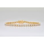 A 9CT GOLD AND DIAMOND BRACELET