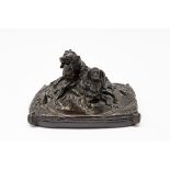 A BRONZE GROUP OF TWO KING CHARLES SPANIELS SEATED ON A CUSHION