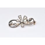 A GOLD BACKED AND SILVER SET DIAMOND FLORAL SPRAY BROOCH