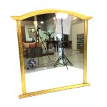 A MODERN GOLD PAINTED ARCHED OVERMANTEL WALL MIRROR