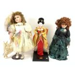 A GROUP OF THREE MODERN DOLLS INCLUDING A PORCELAIN HEADED DOLL FROM THE ‘KNIGHTSBRIDGE’...