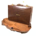 A VINTAGE LEATHER SUITCASE