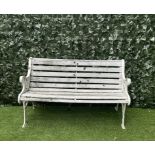 A MODERN WHITE PAINTED CAST IRON AND SLATTED GARDEN BENCH