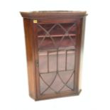 A 19TH CENTURY MAHOGANY GLAZED HANGING CORNER DISPLAY CABINET