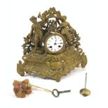 A LATE 19TH CENTURY GILT METAL MANTEL CLOCK MOULDED WITH FIGURES