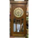 AN EARLY 20TH CENTURY OAK CASED WALL CLOCK