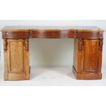 A VICTORIAN STYLE MAHOGANY SERPENTINE PEDESTAL SIDEBOARD