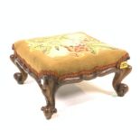 A VICTORIAN MAHOGANY FRAMED LOW SQUARE FOOTSTOOL WITH FLORAL NEEDELEWOK UPHOLSTREY.