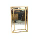 A REGENCY STYLE GOLD PAINTED RECTANGULAR MARGINAL WALL MIRROR