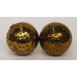 TWO SPHERICAL PIERCED AND ENGRAVED BRASS HAND WARMERS OR ROLLING LAMPS (2)